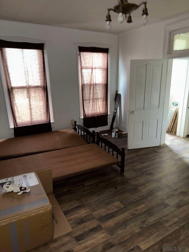 sitting room featuring dark wood-type flooring and a notable chandelier