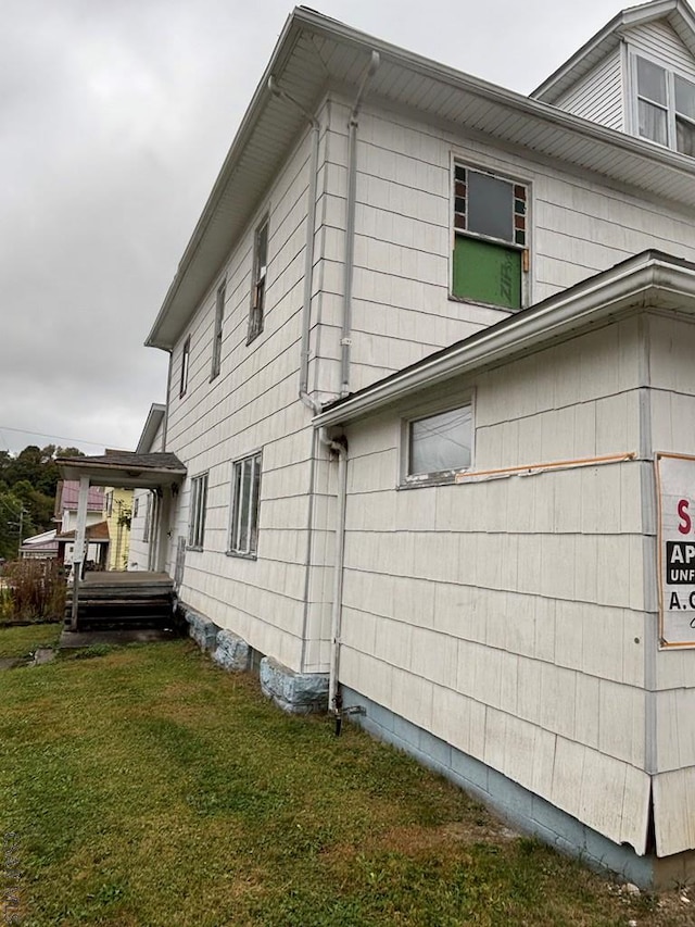 view of side of home with a lawn