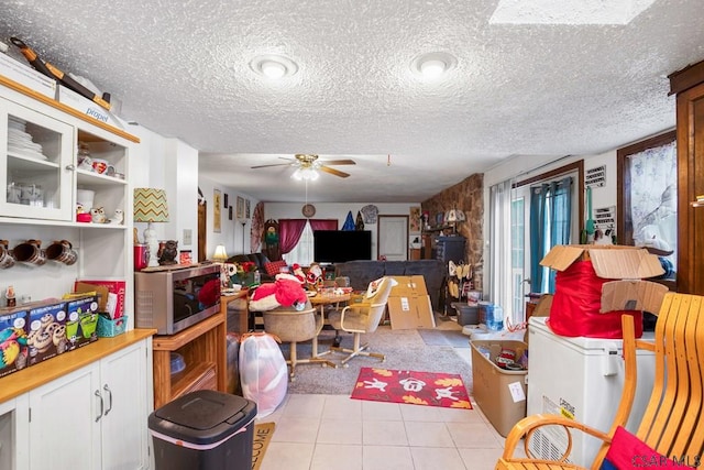 interior space featuring ceiling fan and a textured ceiling