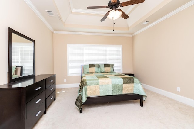 carpeted bedroom featuring ceiling fan, crown molding, and a tray ceiling