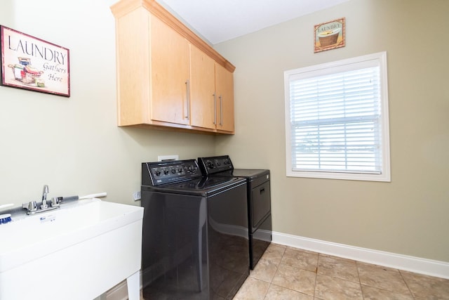 washroom with light tile flooring, cabinets, separate washer and dryer, and sink