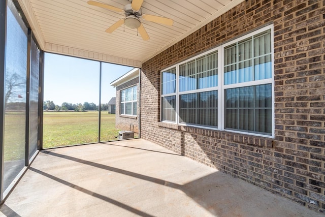 unfurnished sunroom with ceiling fan and a healthy amount of sunlight