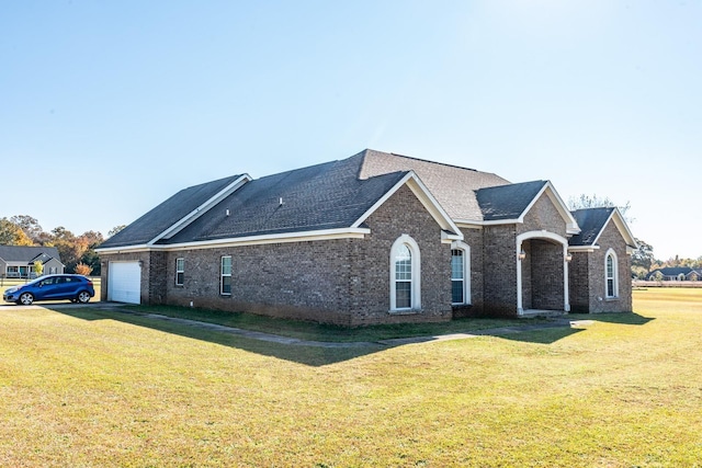 view of property featuring a front lawn and a garage