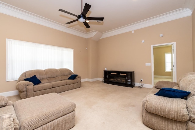 living room featuring light colored carpet, ceiling fan, and crown molding