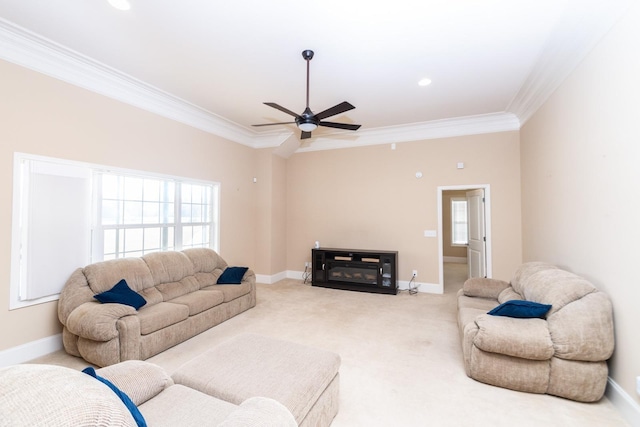 carpeted living room featuring a healthy amount of sunlight, ceiling fan, and crown molding