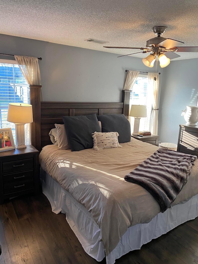 114 Joshua St, Perry, GA 31069 - bedroom with ceiling fan, dark hardwood / wood-style floors, and a textured ceiling