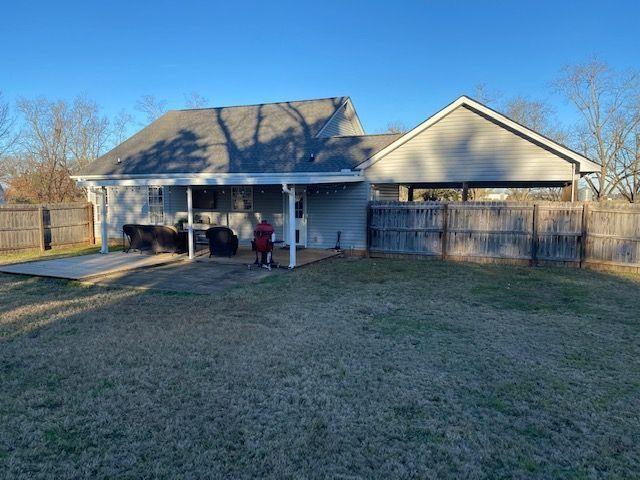 114 Joshua St, Perry, GA 31069 - rear view of house with a lawn