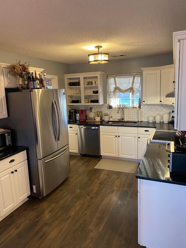114 Joshua St, Perry, GA 31069 - kitchen with tasteful backsplash, stainless steel appliances, sink, and dark wood-type flooring