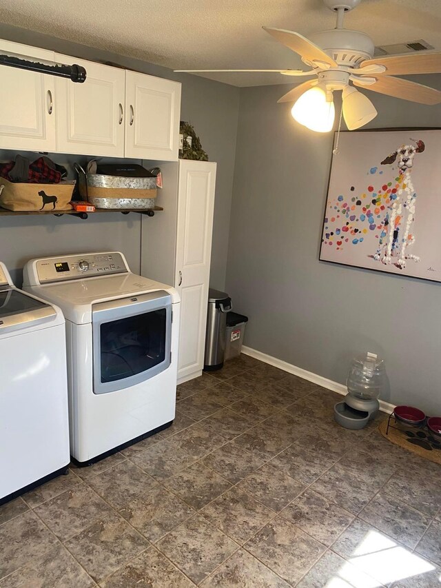 114 Joshua St, Perry, GA 31069 - laundry room featuring washing machine and dryer, cabinets, dark tile flooring, and ceiling fan