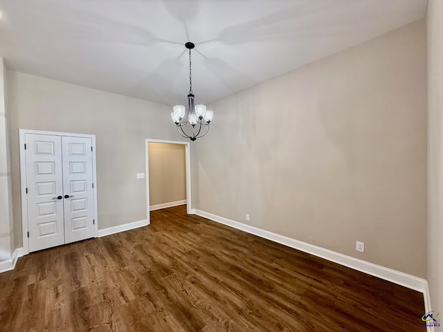 interior space with a chandelier, baseboards, and wood finished floors