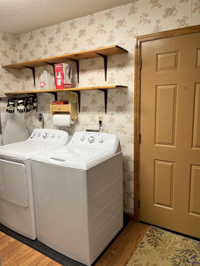 2382 Gallimore Mill Rd, Jeffersonville, GA 31044 - laundry room with separate washer and dryer, wood finished floors, and wallpapered walls