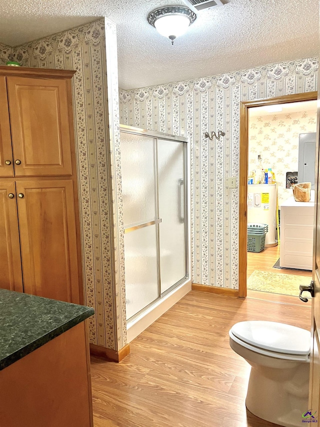 2382 Gallimore Mill Rd, Jeffersonville, GA 31044 - full bath featuring wood finished floors, wallpapered walls, a shower stall, a textured ceiling, and vanity