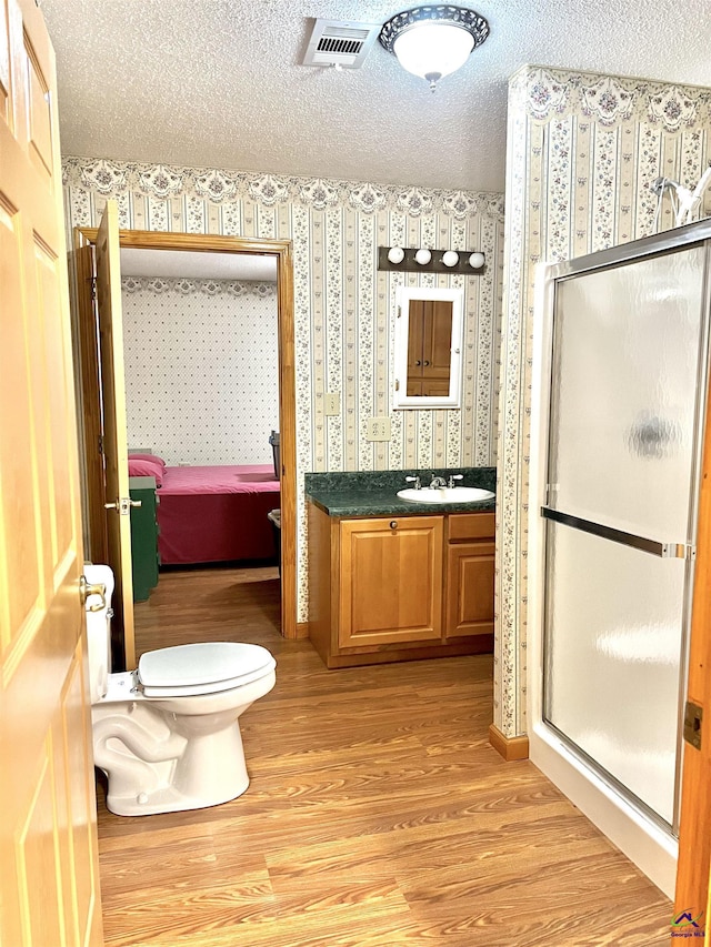 2382 Gallimore Mill Rd, Jeffersonville, GA 31044 - full bathroom with wallpapered walls, wood finished floors, vanity, a stall shower, and ensuite bath