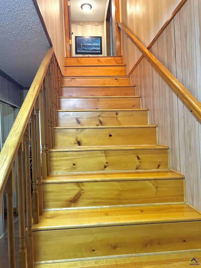 2382 Gallimore Mill Rd, Jeffersonville, GA 31044 - stairway with wood walls and a textured ceiling