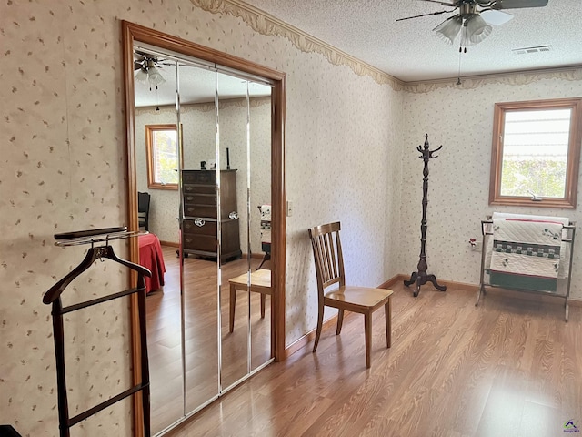 2382 Gallimore Mill Rd, Jeffersonville, GA 31044 - sitting room with ceiling fan, wood finished floors, wallpapered walls, and a textured ceiling