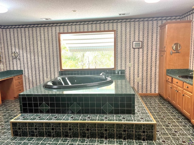 2382 Gallimore Mill Rd, Jeffersonville, GA 31044 - bathroom with a bath, wallpapered walls, a textured ceiling, and vanity