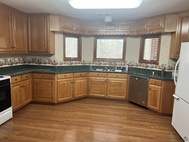 2382 Gallimore Mill Rd, Jeffersonville, GA 31044 - kitchen with dishwasher, stove, freestanding refrigerator, and wood finished floors