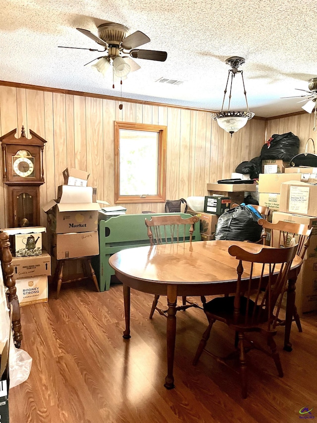 2382 Gallimore Mill Rd, Jeffersonville, GA 31044 - dining room featuring a ceiling fan, a textured ceiling, wooden walls, and light wood-type flooring