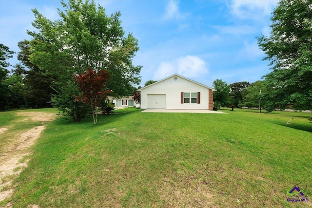 exterior space with a garage and a lawn