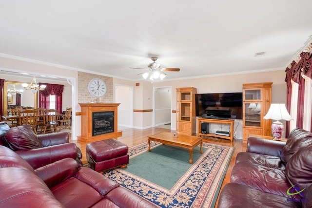 living room featuring hardwood / wood-style flooring, ceiling fan with notable chandelier, and ornamental molding