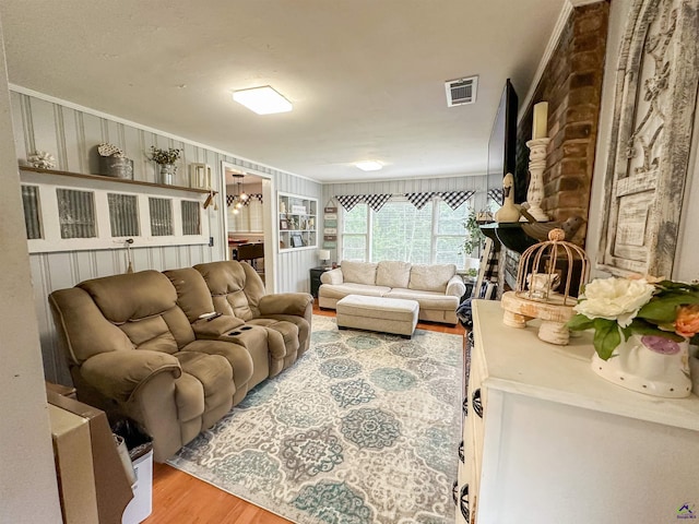 living room with a chandelier and light hardwood / wood-style floors