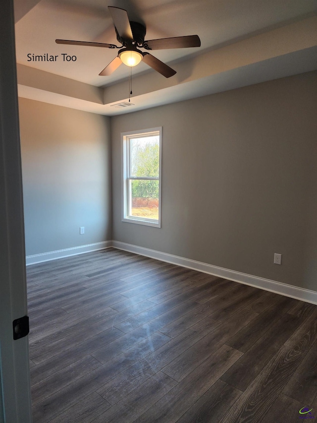 spare room with ceiling fan and dark hardwood / wood-style floors