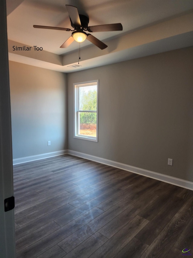 empty room featuring dark hardwood / wood-style flooring and ceiling fan