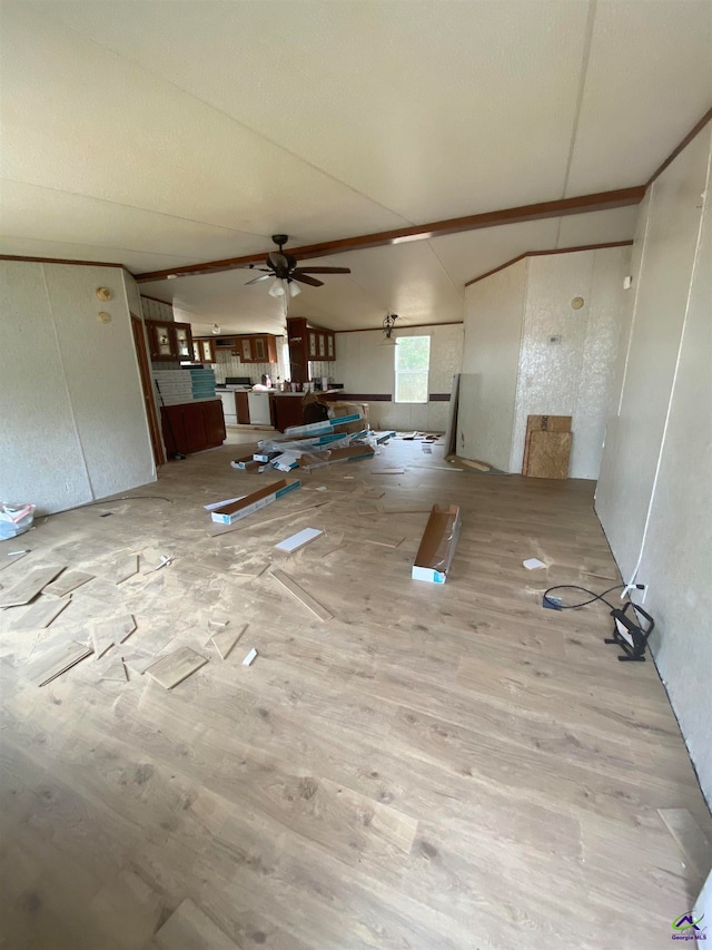 interior space with light hardwood / wood-style floors, ceiling fan, and vaulted ceiling