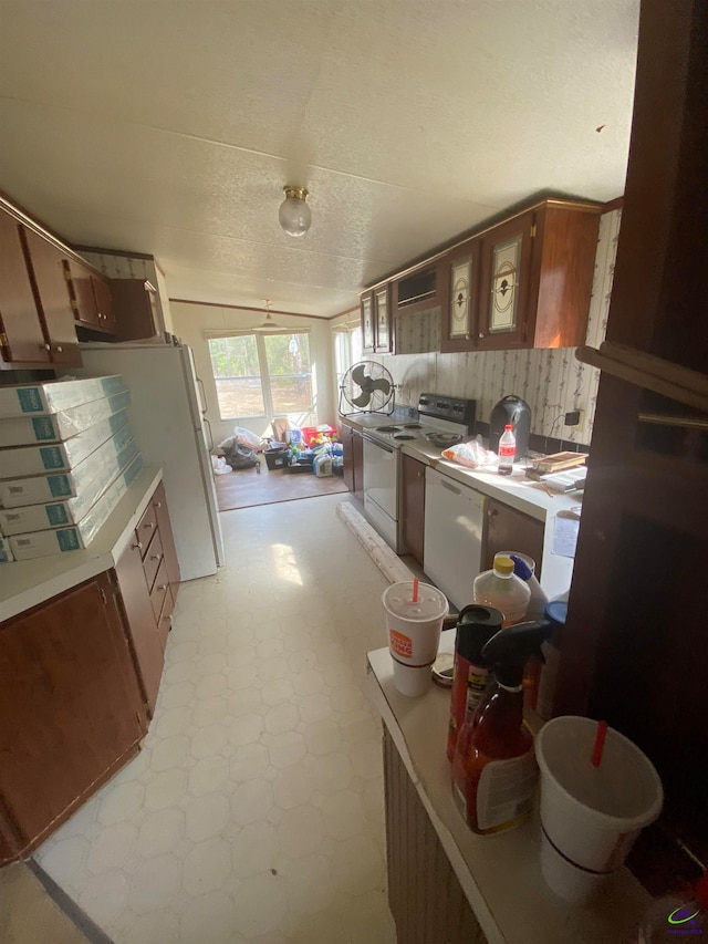 kitchen featuring tasteful backsplash, light tile floors, a textured ceiling, white dishwasher, and electric stove