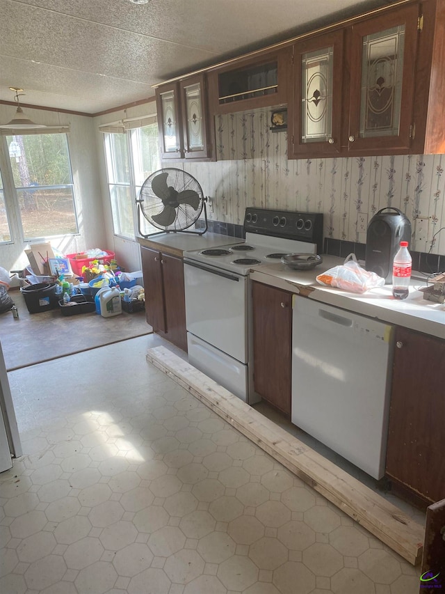 kitchen featuring white appliances, a textured ceiling, and light tile floors