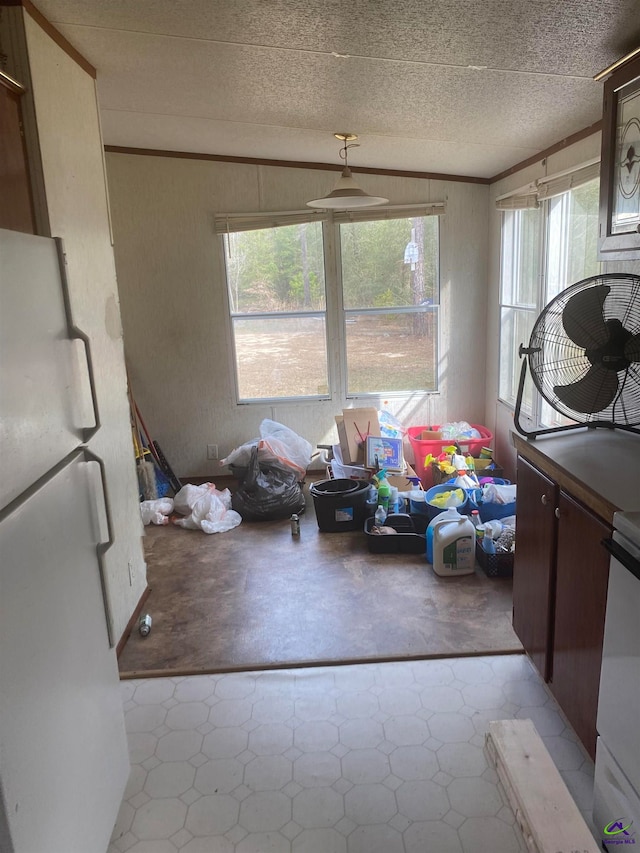 misc room featuring lofted ceiling, light tile floors, and plenty of natural light