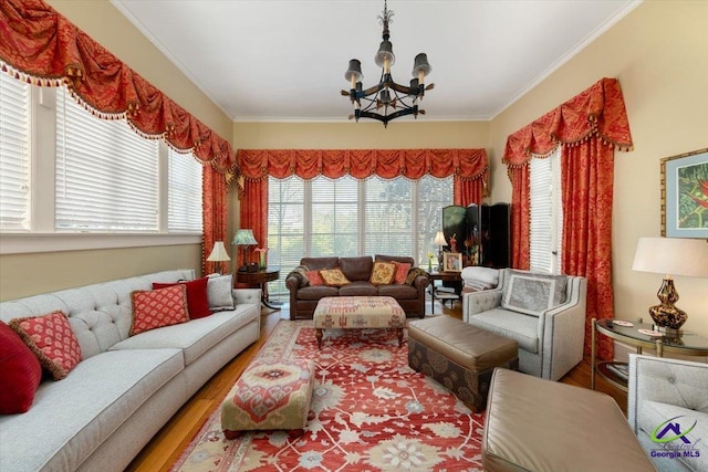 living room featuring ornamental molding, a notable chandelier, and hardwood / wood-style flooring