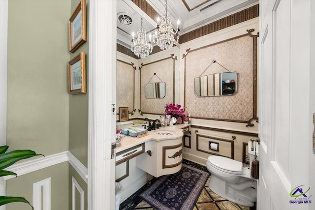 bathroom with an inviting chandelier, tile flooring, toilet, sink, and ornamental molding