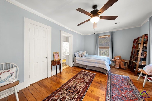 bedroom with ornamental molding, ceiling fan, and light wood-type flooring