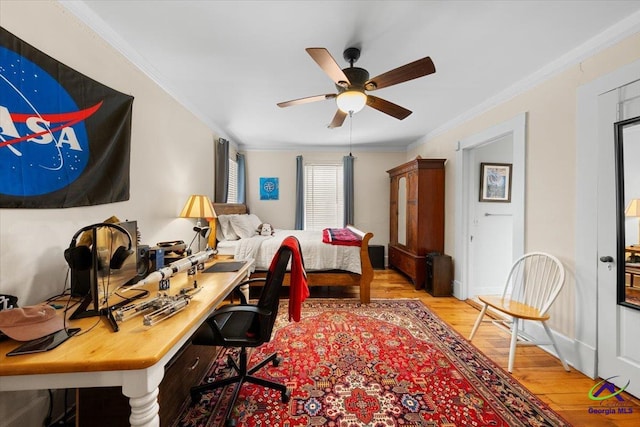 office space featuring ornamental molding, ceiling fan, and light hardwood / wood-style flooring