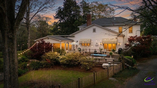 view of back house at dusk