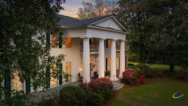 outdoor structure at dusk featuring a yard