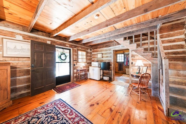 entrance foyer with beam ceiling, log walls, wood ceiling, and light hardwood / wood-style floors