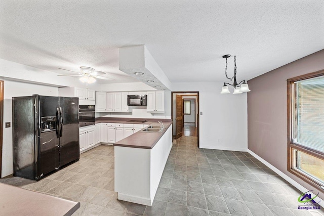 kitchen with ceiling fan with notable chandelier, black appliances, light tile floors, white cabinets, and pendant lighting