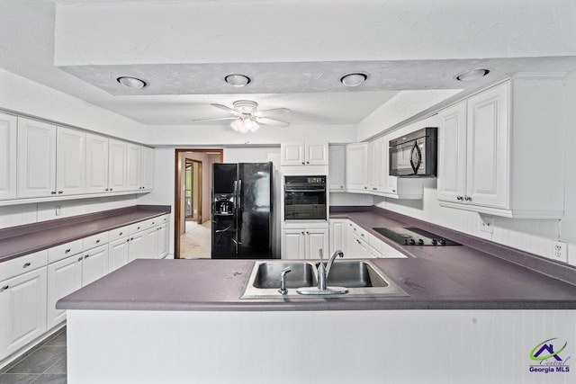 kitchen featuring white cabinetry, ceiling fan, black appliances, and sink