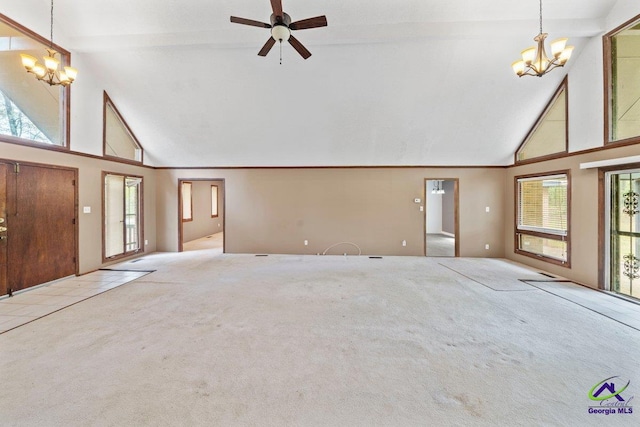 unfurnished living room featuring light tile floors, high vaulted ceiling, and ceiling fan with notable chandelier