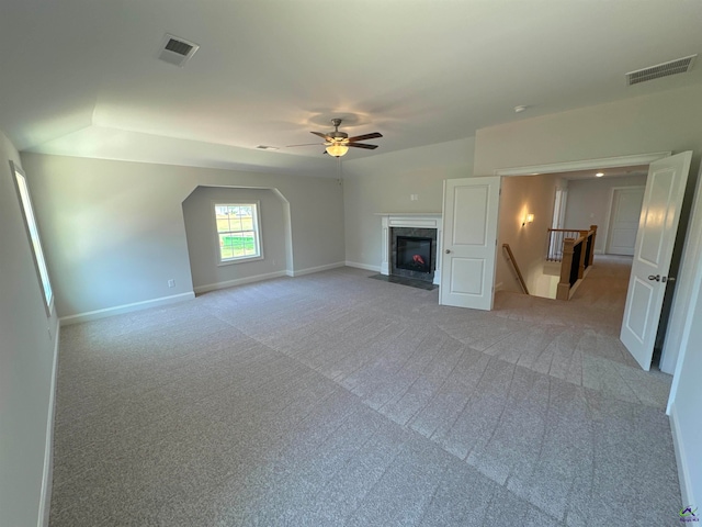 unfurnished living room with ceiling fan and light colored carpet