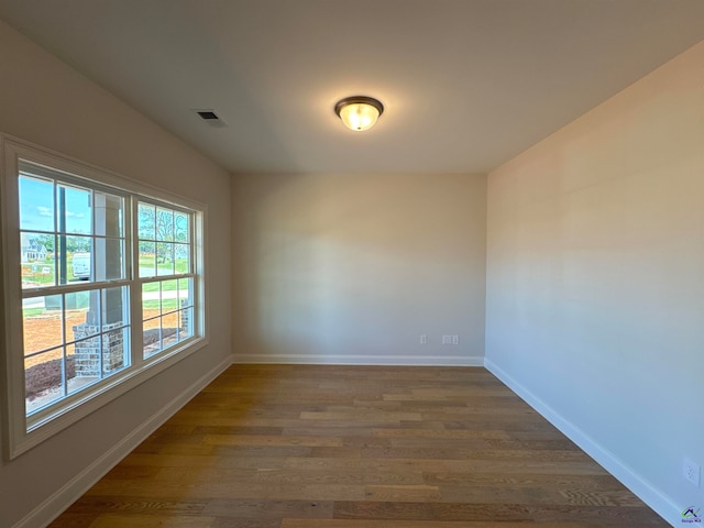 spare room with dark hardwood / wood-style floors