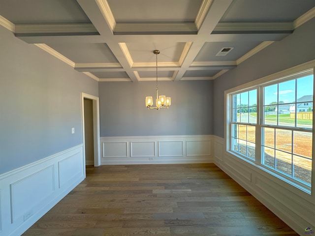 unfurnished room with beamed ceiling, dark hardwood / wood-style floors, coffered ceiling, and an inviting chandelier