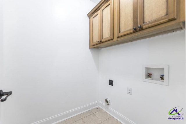 washroom featuring light tile patterned floors, washer hookup, hookup for an electric dryer, and cabinets