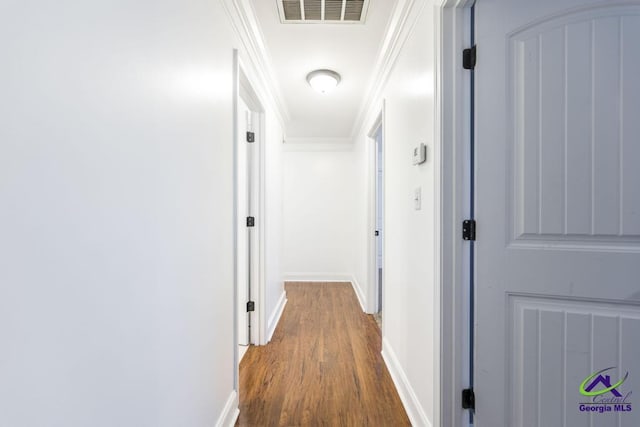 hallway featuring crown molding and hardwood / wood-style floors