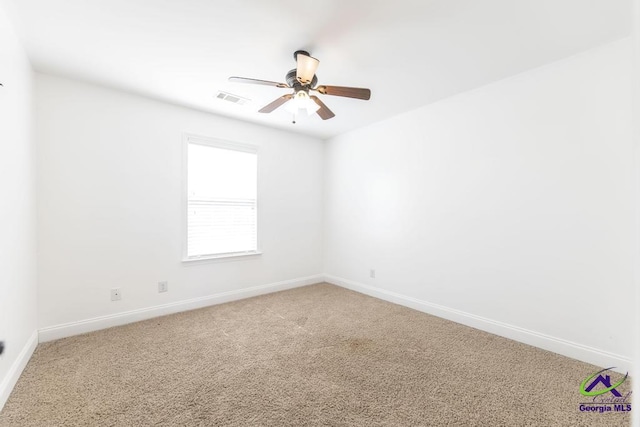 carpeted empty room featuring ceiling fan