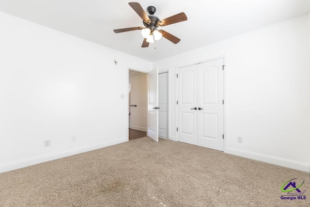 unfurnished bedroom featuring ceiling fan and carpet floors