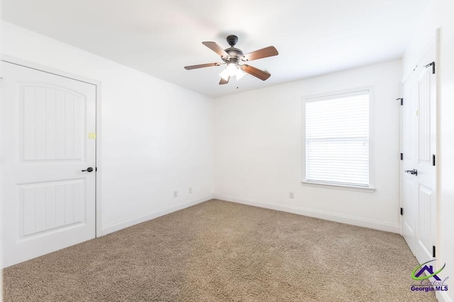 carpeted empty room featuring ceiling fan