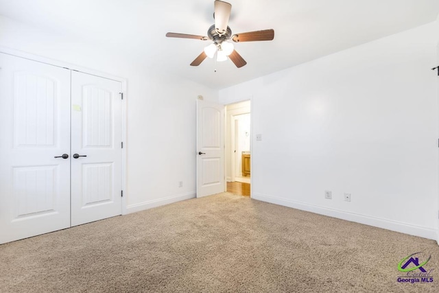 unfurnished bedroom with ceiling fan, a closet, and carpet floors